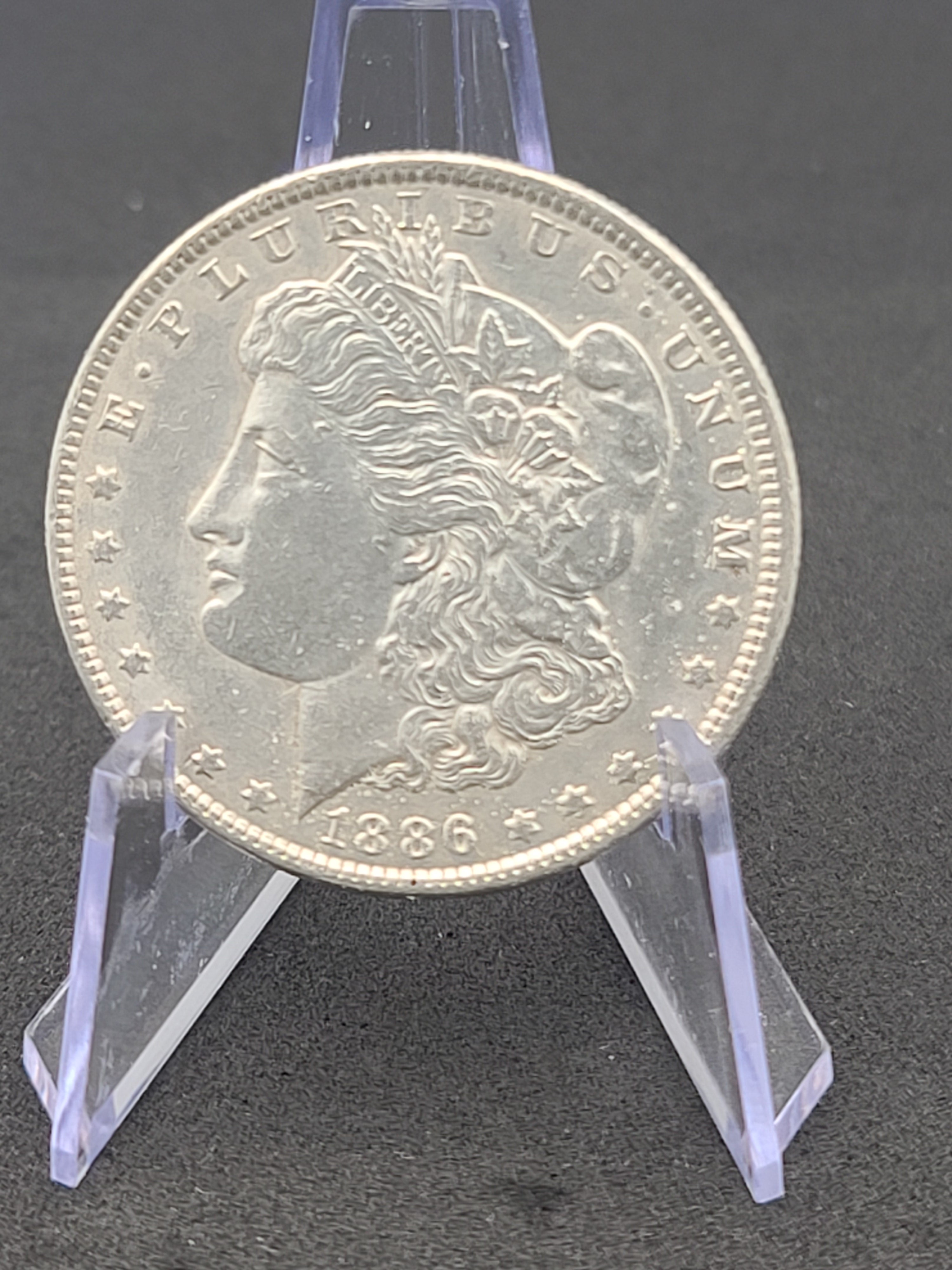 1886 Morgan Dollar in 100 Year Old History Of The Morgan Dollar Folder